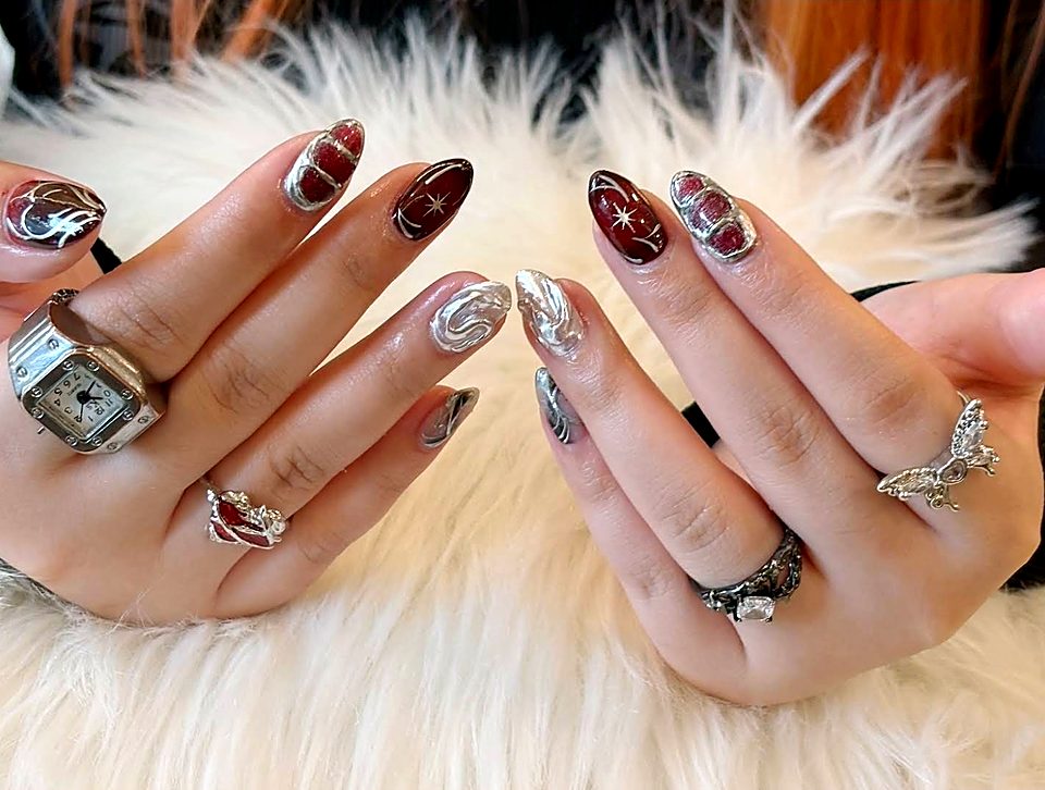 Deep red and silver chrome nail art on both hands