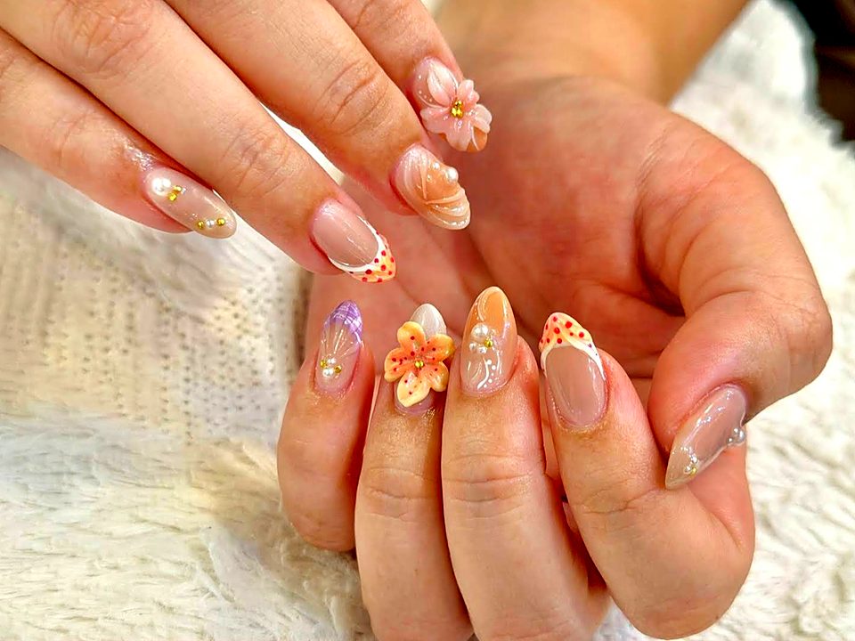 Nude nails with 3D flowers, pearls and french tips
