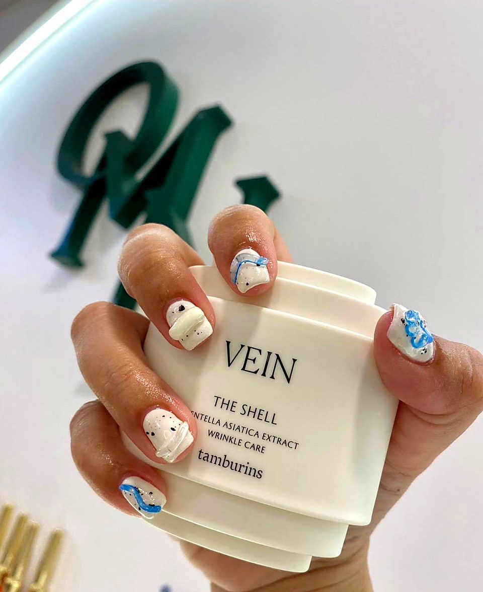 White nails with speckles and blue 3D lines